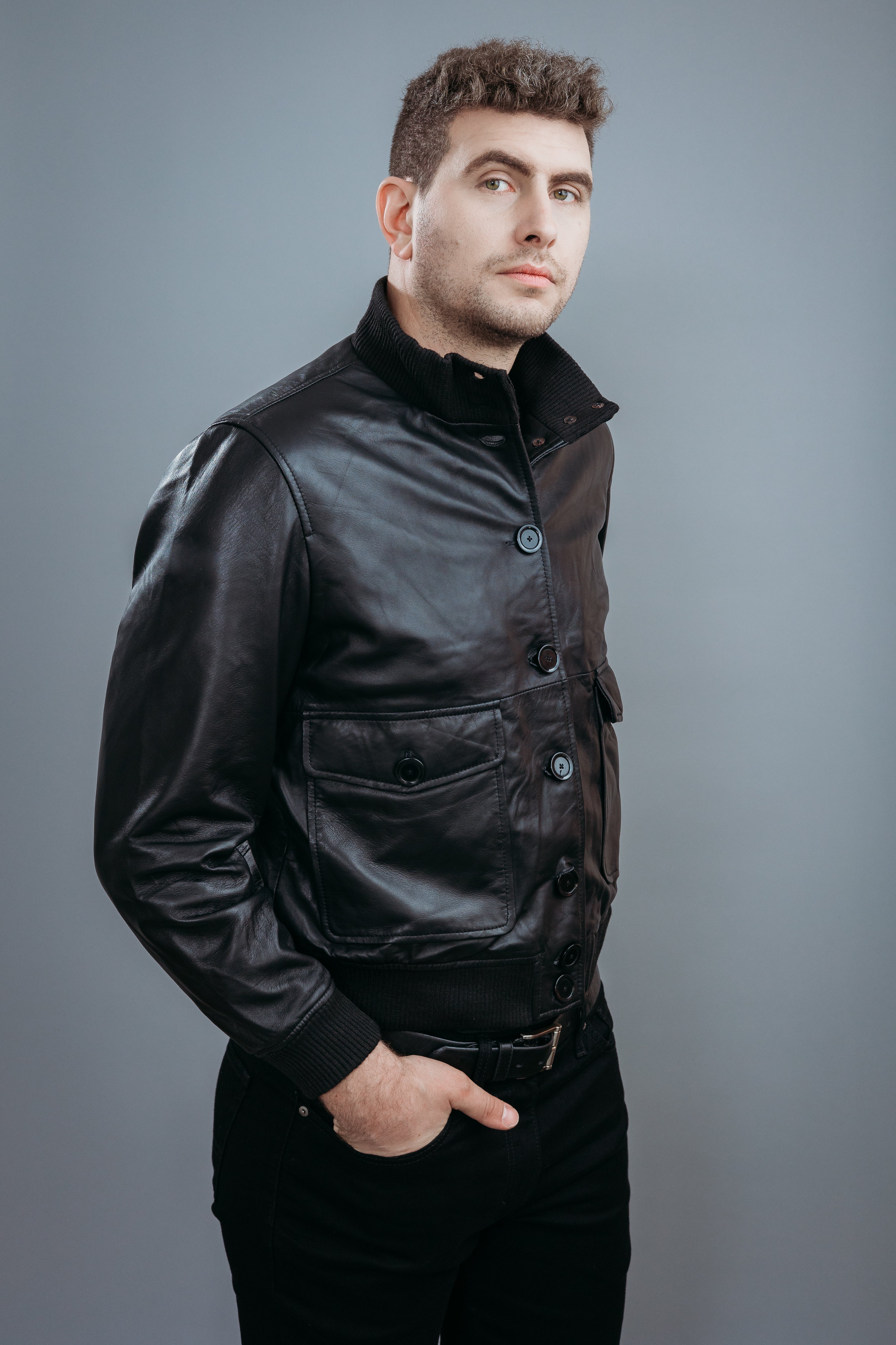 Men's Bomber Jacket made with Semi Aniline Sheep Leather in Black Colour. Inner Lining is Silk Satin Material in Black Colour. It has Black Plastic Buttons.