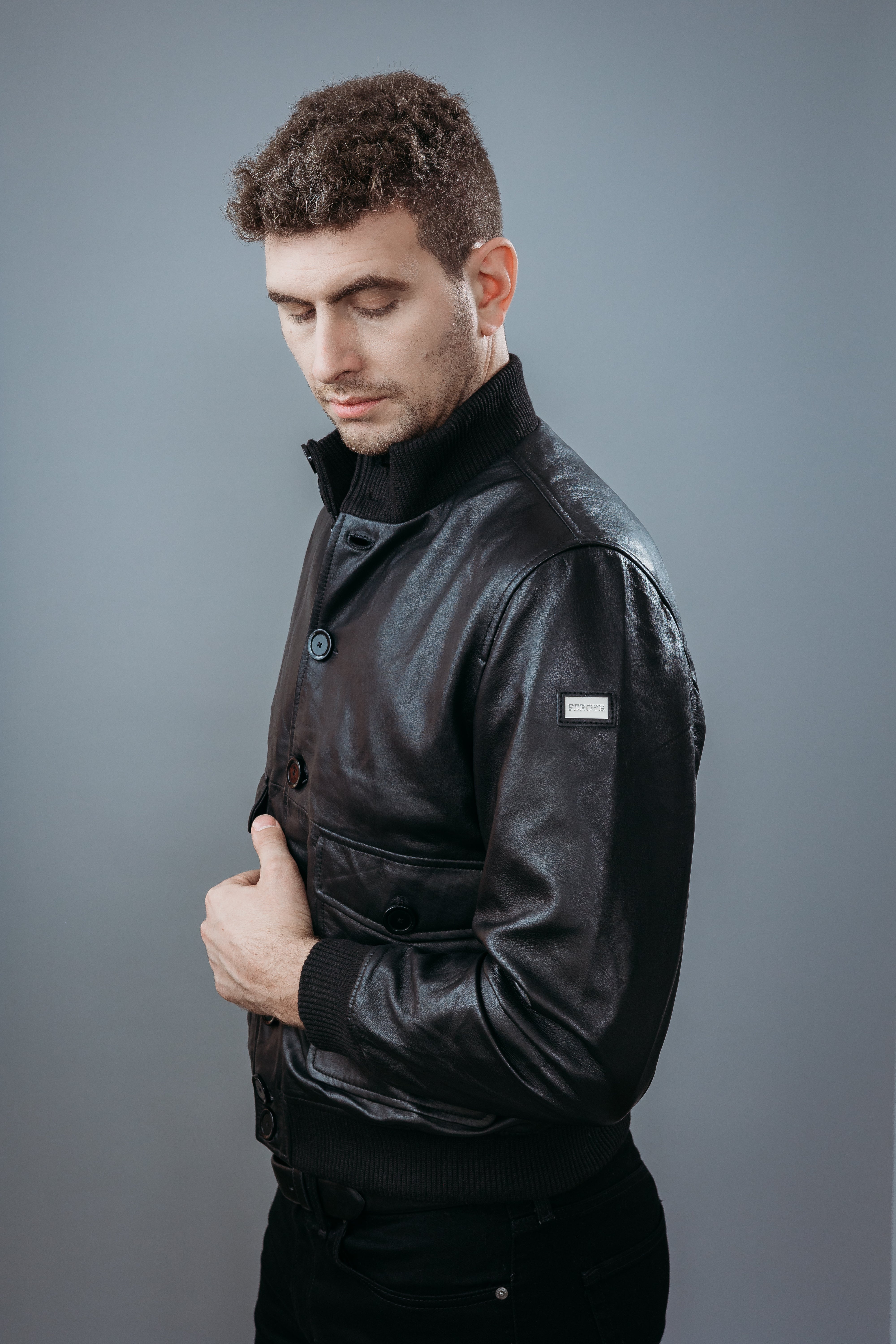 Men's Bomber Jacket made with Semi Aniline Sheep Leather in Black Colour. Inner Lining is Silk Satin Material in Black Colour. It has Black Plastic Buttons.