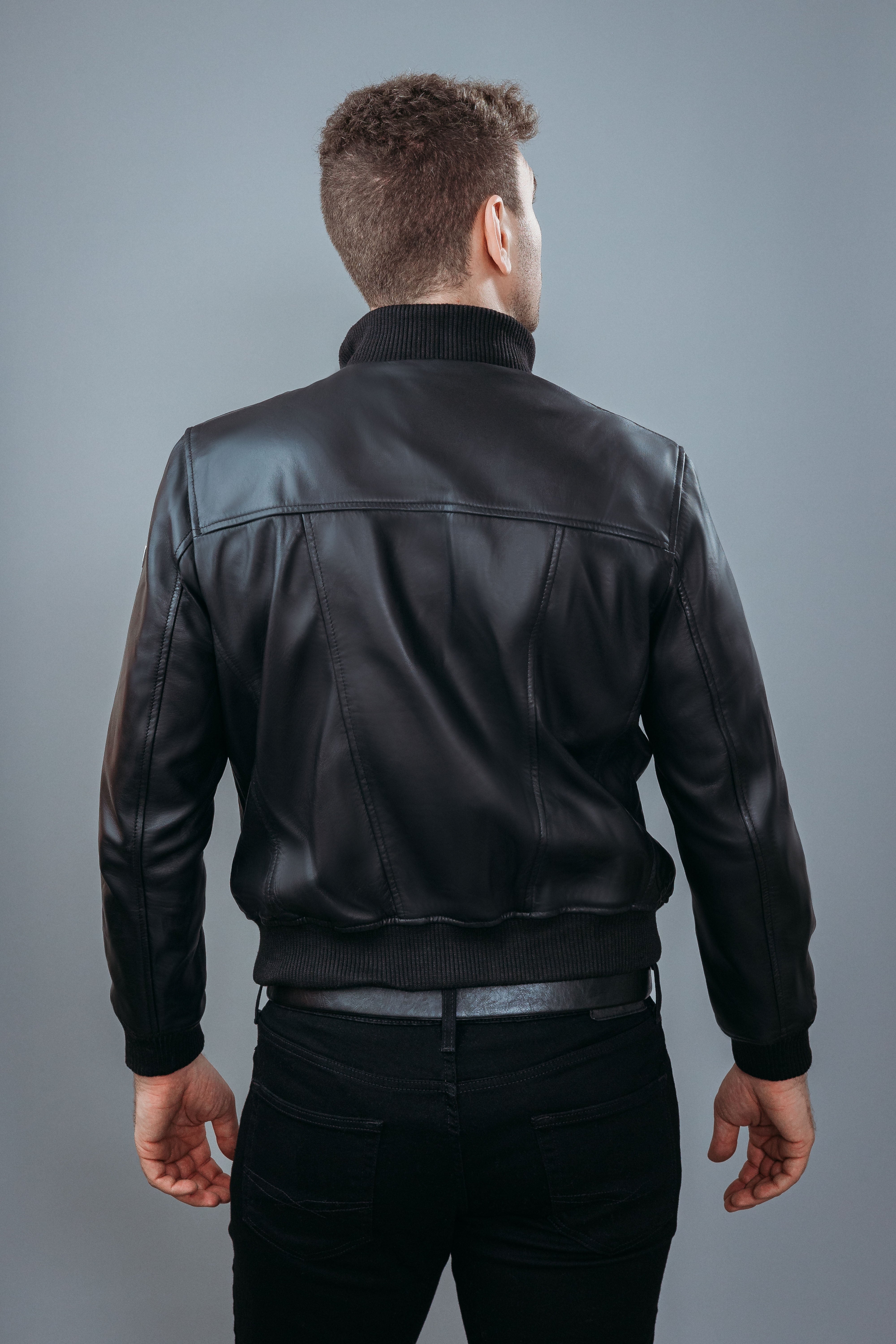 Men's Bomber Jacket made with Semi Aniline Sheep Leather in Black Colour. Inner Lining is Silk Satin Material in Black Colour. It has Black Plastic Buttons.