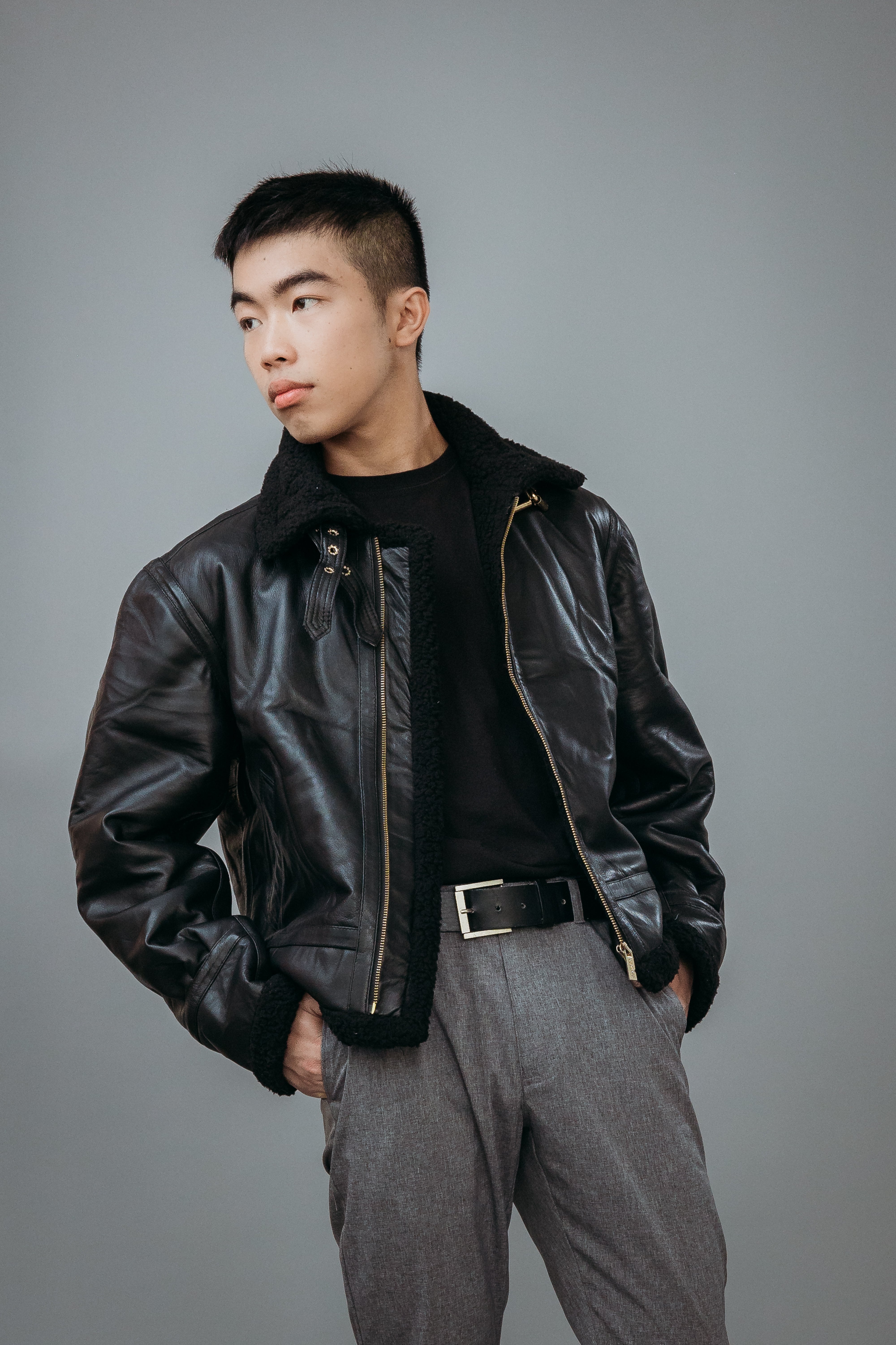 Men's Faux Fur Aviator Style Jacket made with Semi Aniline Sheep Leather in Black Colour. Inner Lining is Faux Fur Material in Black Colour. It has Zipper and Golden Trim.