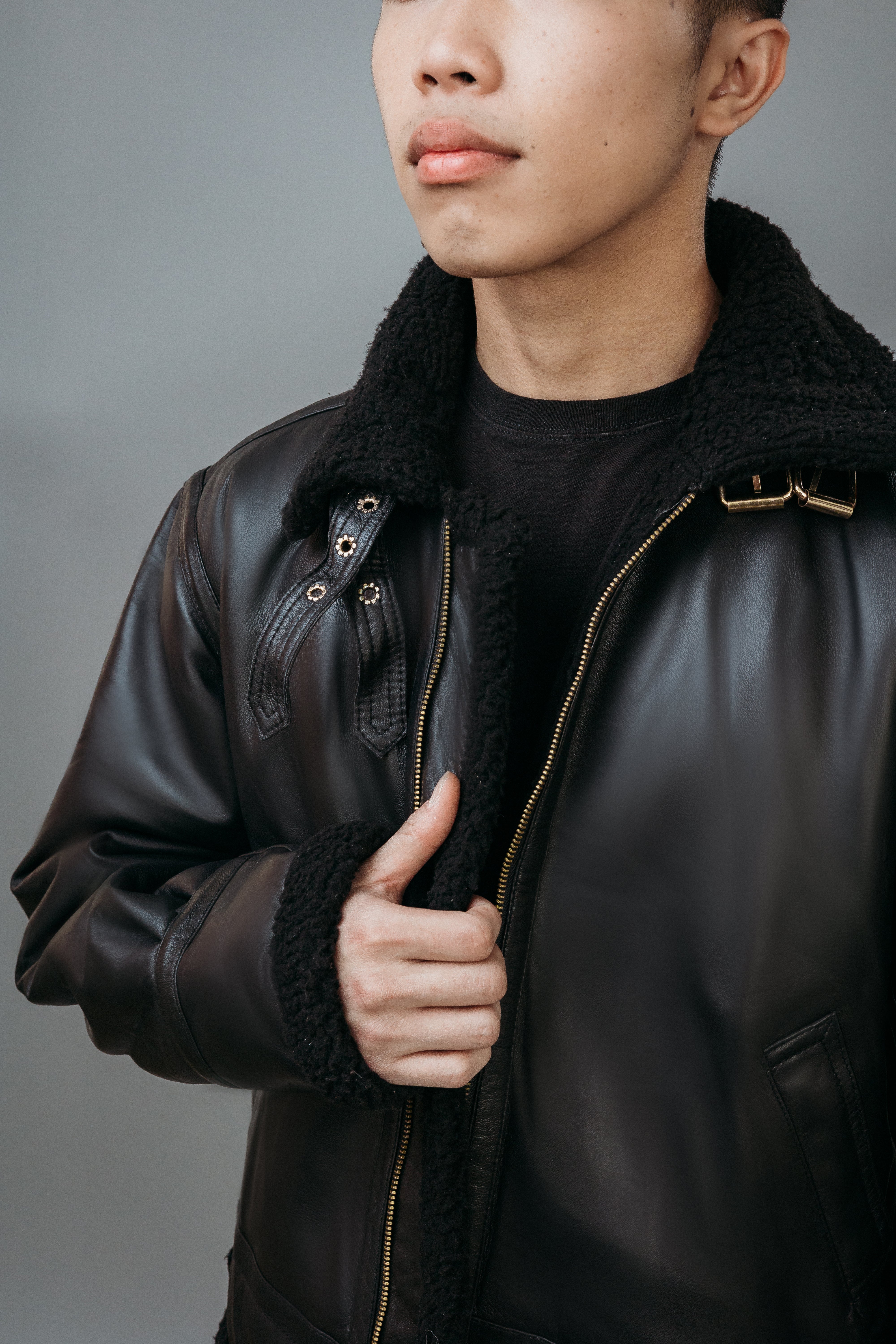 Men's Faux Fur Aviator Style Jacket made with Semi Aniline Sheep Leather in Black Colour. Inner Lining is Faux Fur Material in Black Colour. It has Zipper and Golden Trim.