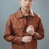 Men's Jeans Style Jacket made with Sheep Top Grain Nappa Leather in Brown Colour. Inner Lining is Silk Satin Material in Brown Colour. It has Brown Plastic Buttons.