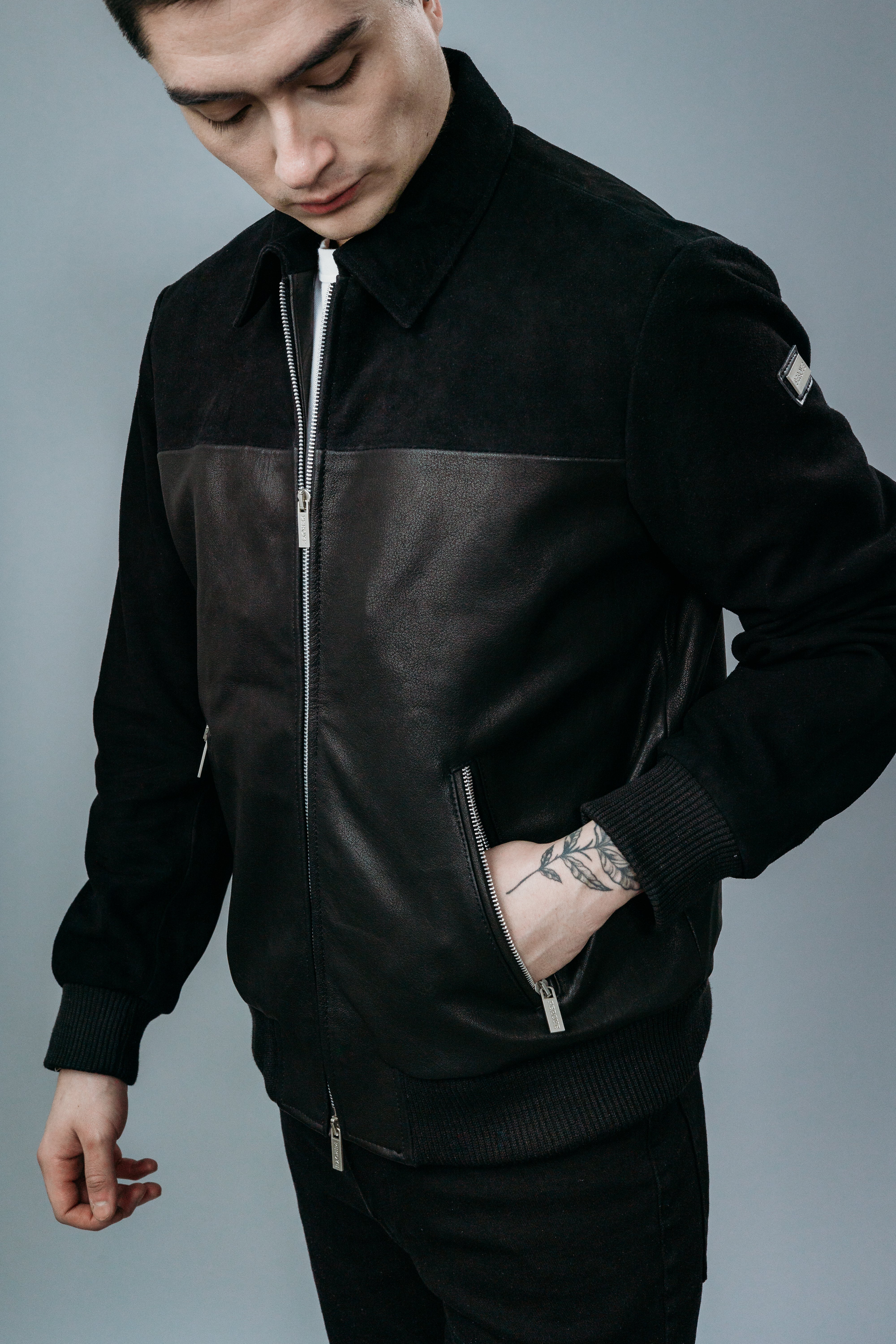 Men's Shirt Collar Style Bomber Jacket made with Sheep Semi Aniline Leather and partially with Goat Suede Leather both in Black Colour. Inner Lining is Silk Satin Material in Black Colour. It has Zipper and Matte Silver Trim.