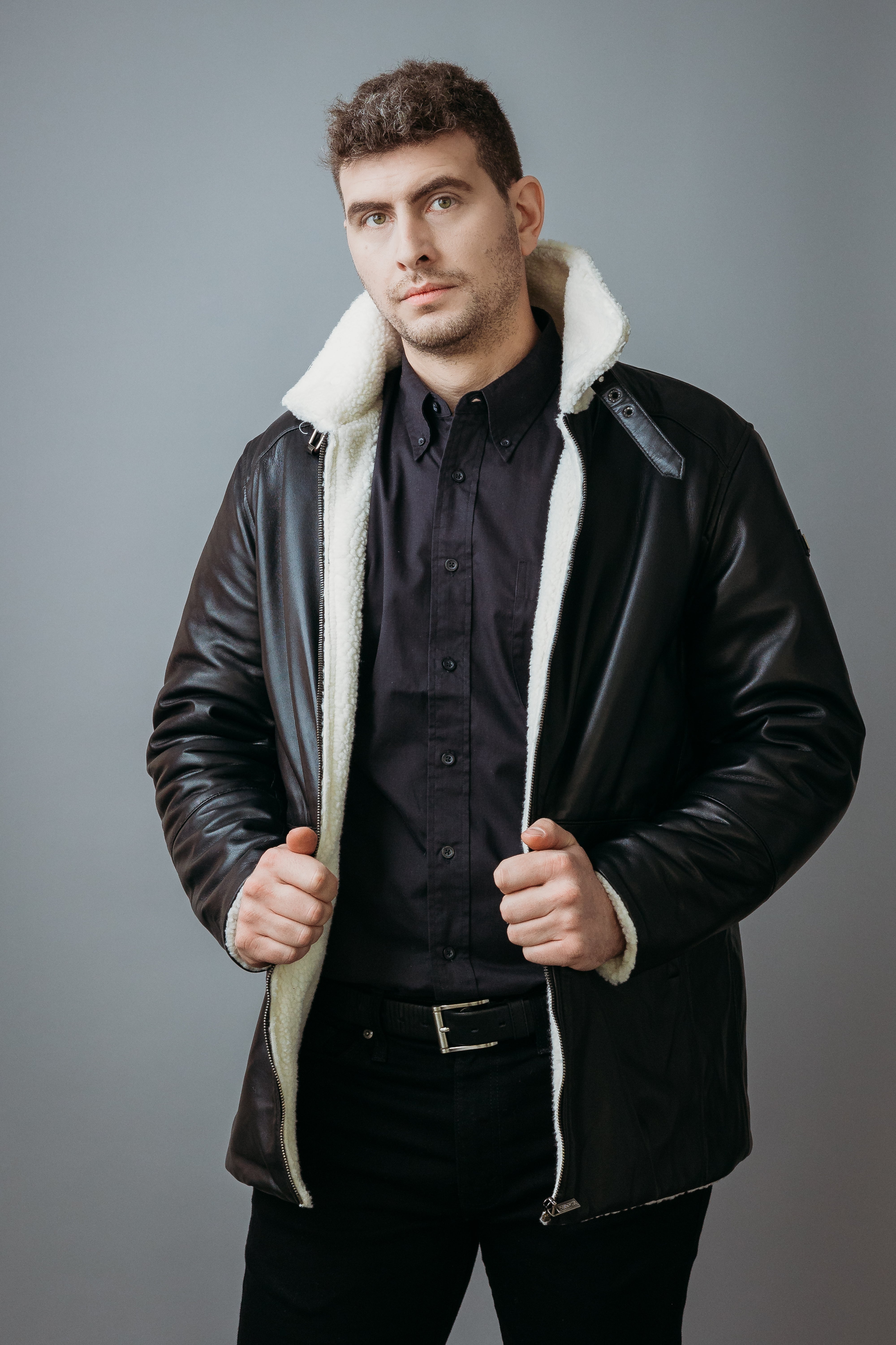 Men's Three Quarter Style Faux Fur Jacket made with Semi Aniline Sheep Leather in Black Colour. Inner Lining is Faux Fur Material in White Colour. It has Zipper and Gun Metal Trim.