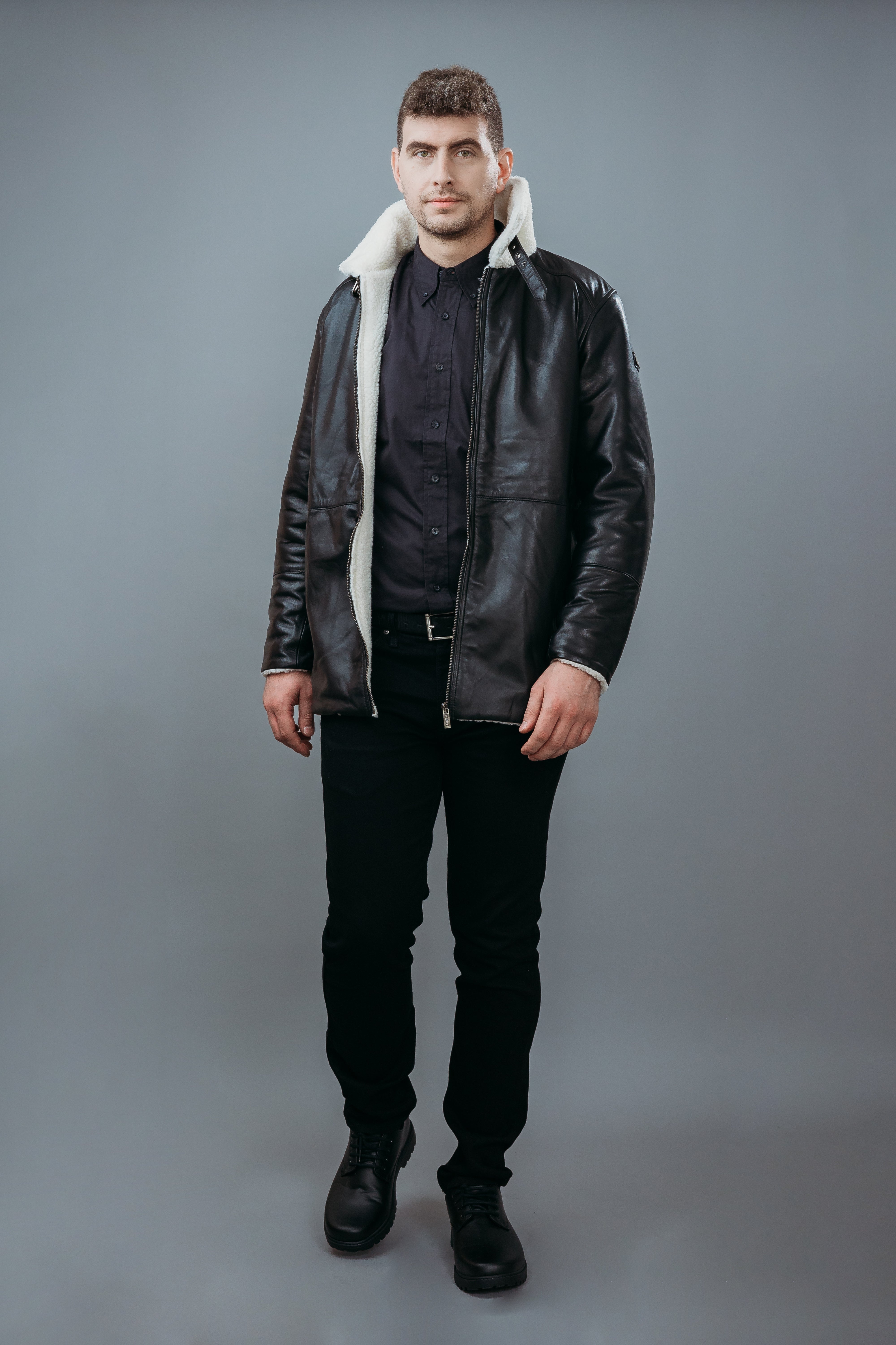 Men's Three Quarter Style Faux Fur Jacket made with Semi Aniline Sheep Leather in Black Colour. Inner Lining is Faux Fur Material in White Colour. It has Zipper and Gun Metal Trim.