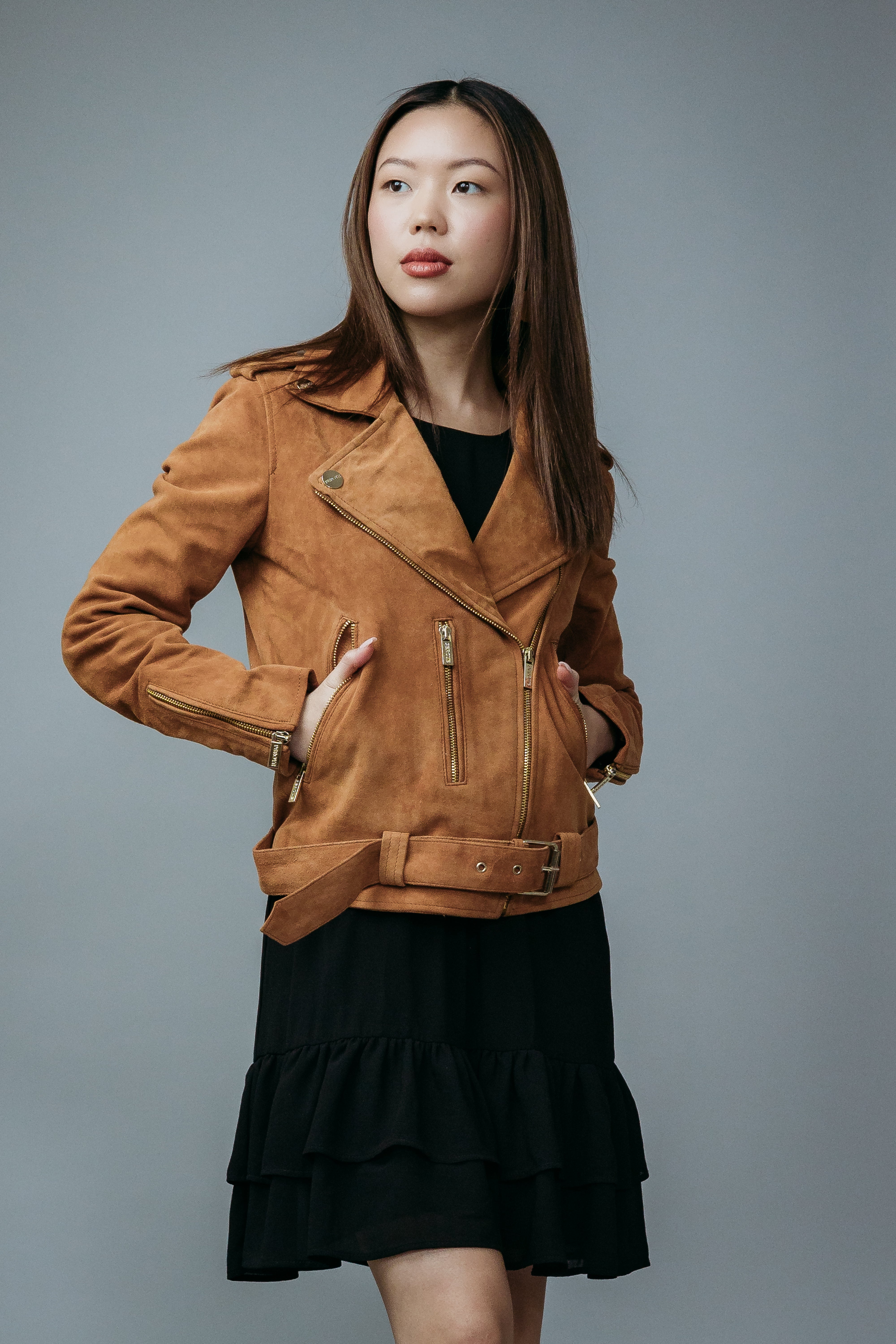 Women's Biker Jacket made with Suede Goat Leather in Brown Colour. Inner Lining is Silk Satin Material in Brown Colour. It has Zipper and Golden Trim.