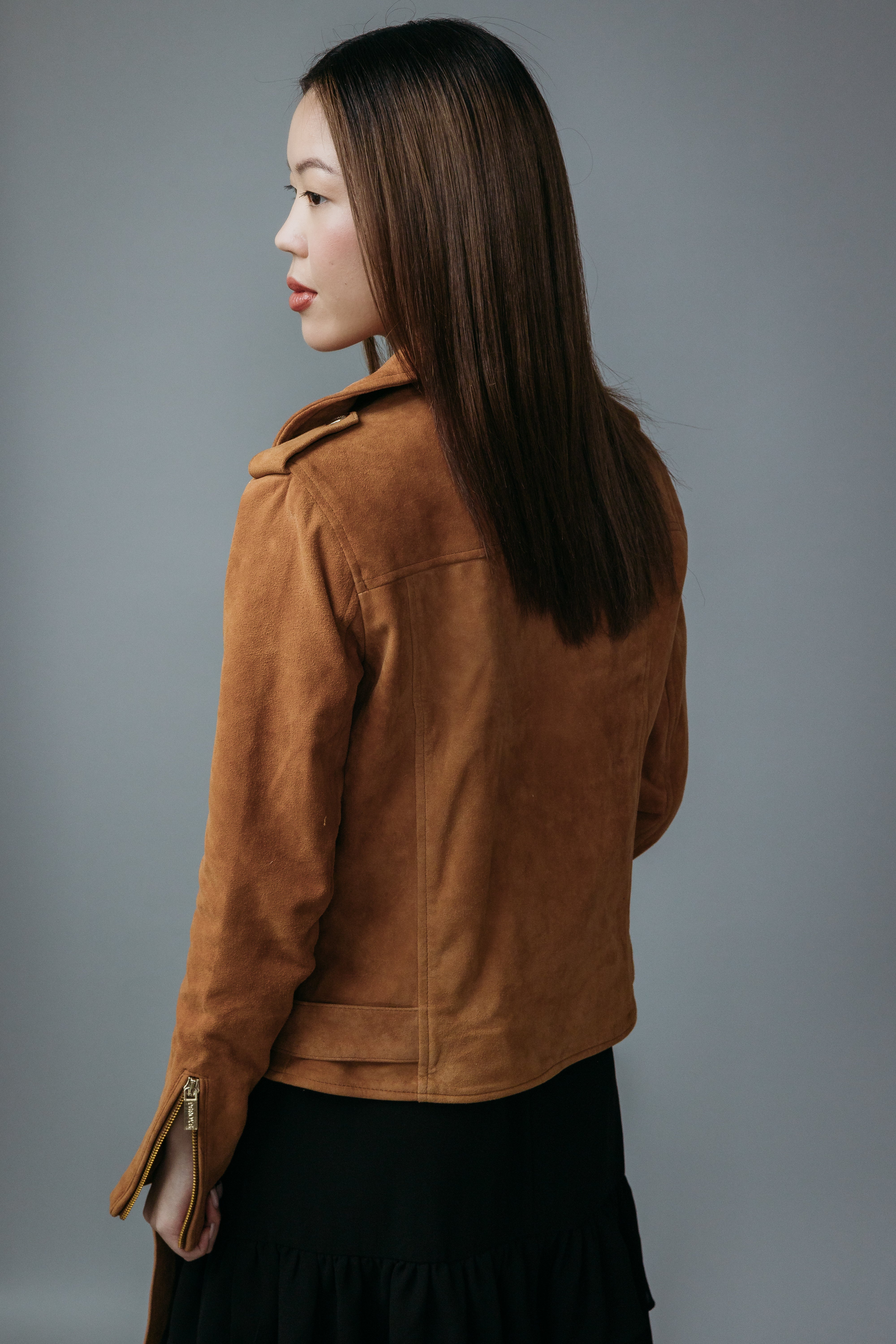 Women's Biker Jacket made with Suede Goat Leather in Brown Colour. Inner Lining is Silk Satin Material in Brown Colour. It has Zipper and Golden Trim.