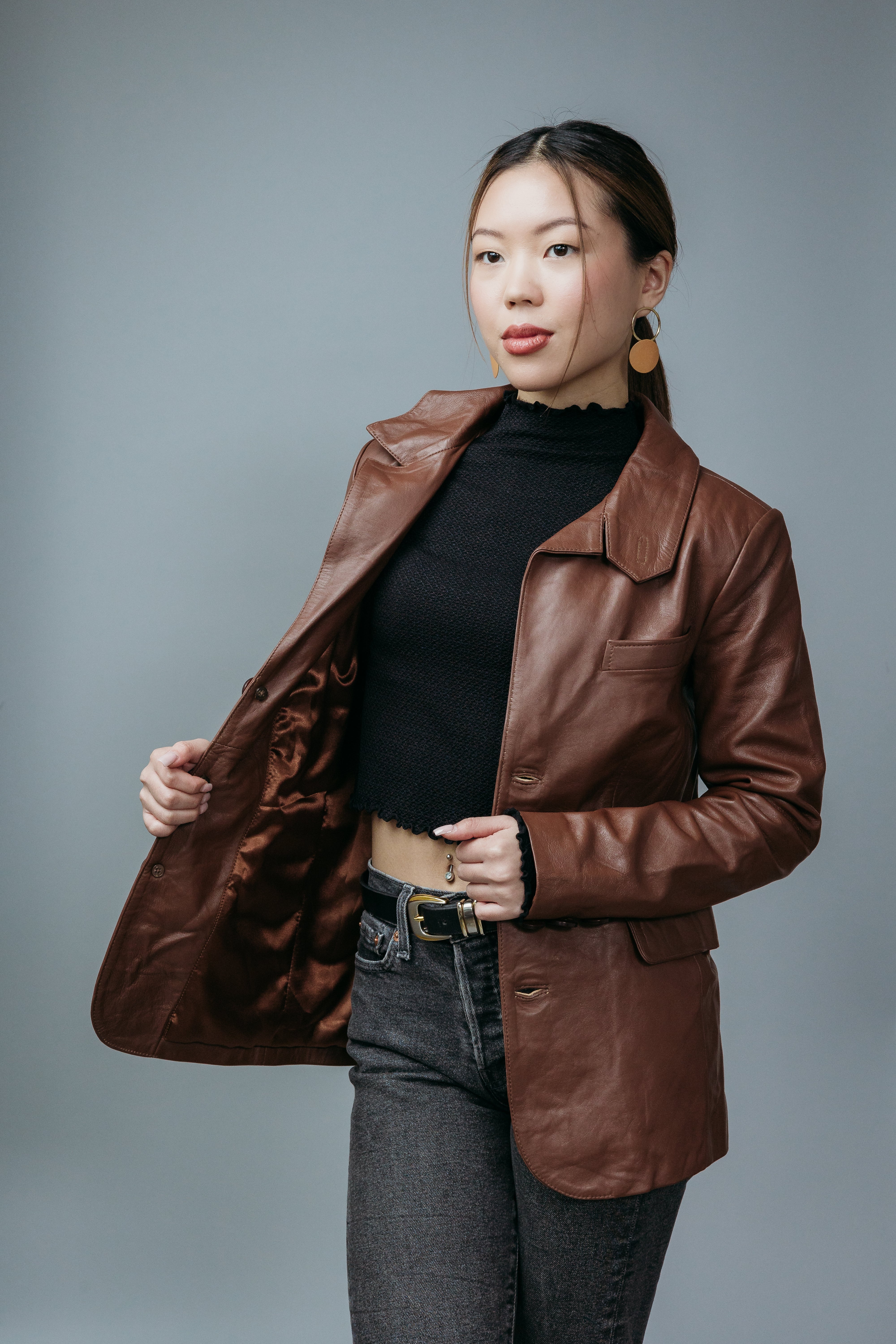 Women's Blazer Style Jacket made with Sheep Top Grain Nappa Leather in Brown Colour. Inner Lining is Silk Satin Material in Brown Colour. It has Brown Plastic Buttons.