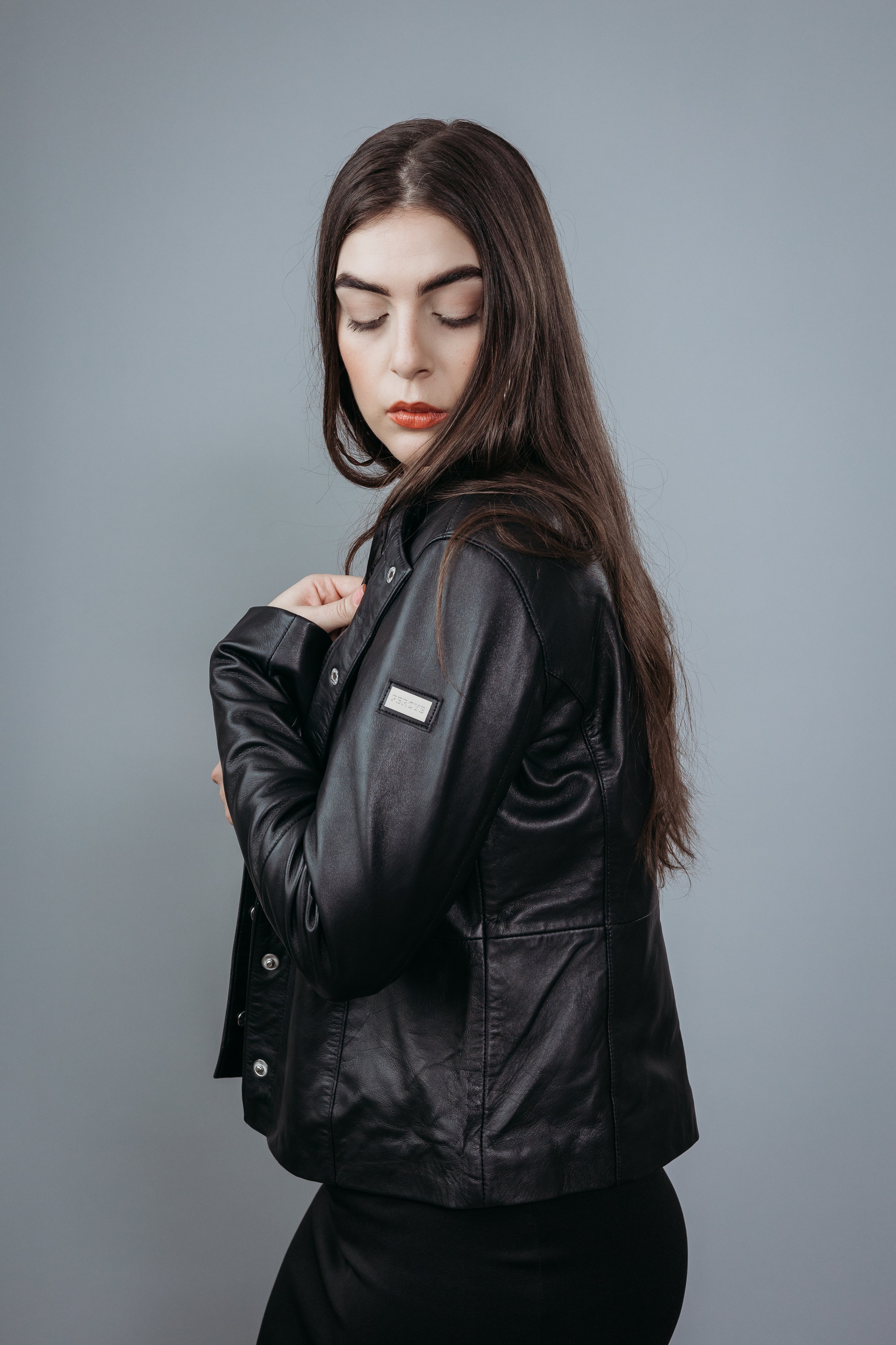 Women's Shirt Style Collarless Jacket made with Semi Aniline Sheep Leather in Black Colour. Inner Lining is Silk Satin Material in Black Colour. It has Black and Silver Trim.