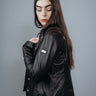 Women's Shirt Style Collarless Jacket made with Semi Aniline Sheep Leather in Black Colour. Inner Lining is Silk Satin Material in Black Colour. It has Black and Silver Trim.