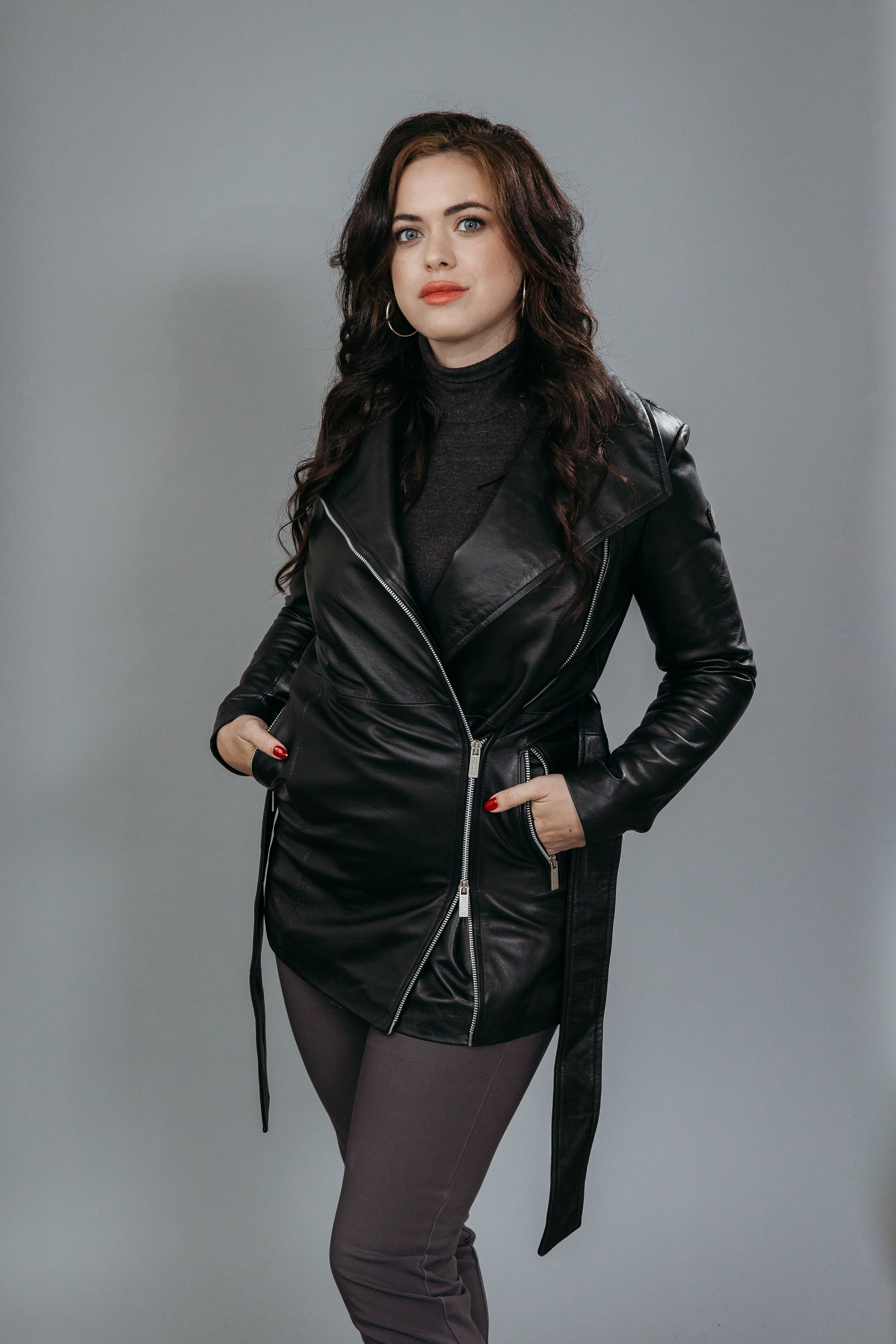 Women's Trench Coat made with Semi-Aniline Sheep Leather in Black Colour. Inner Lining is Silk Satin Material in Black Colour. It has Zipper and Matte Silver Trim.