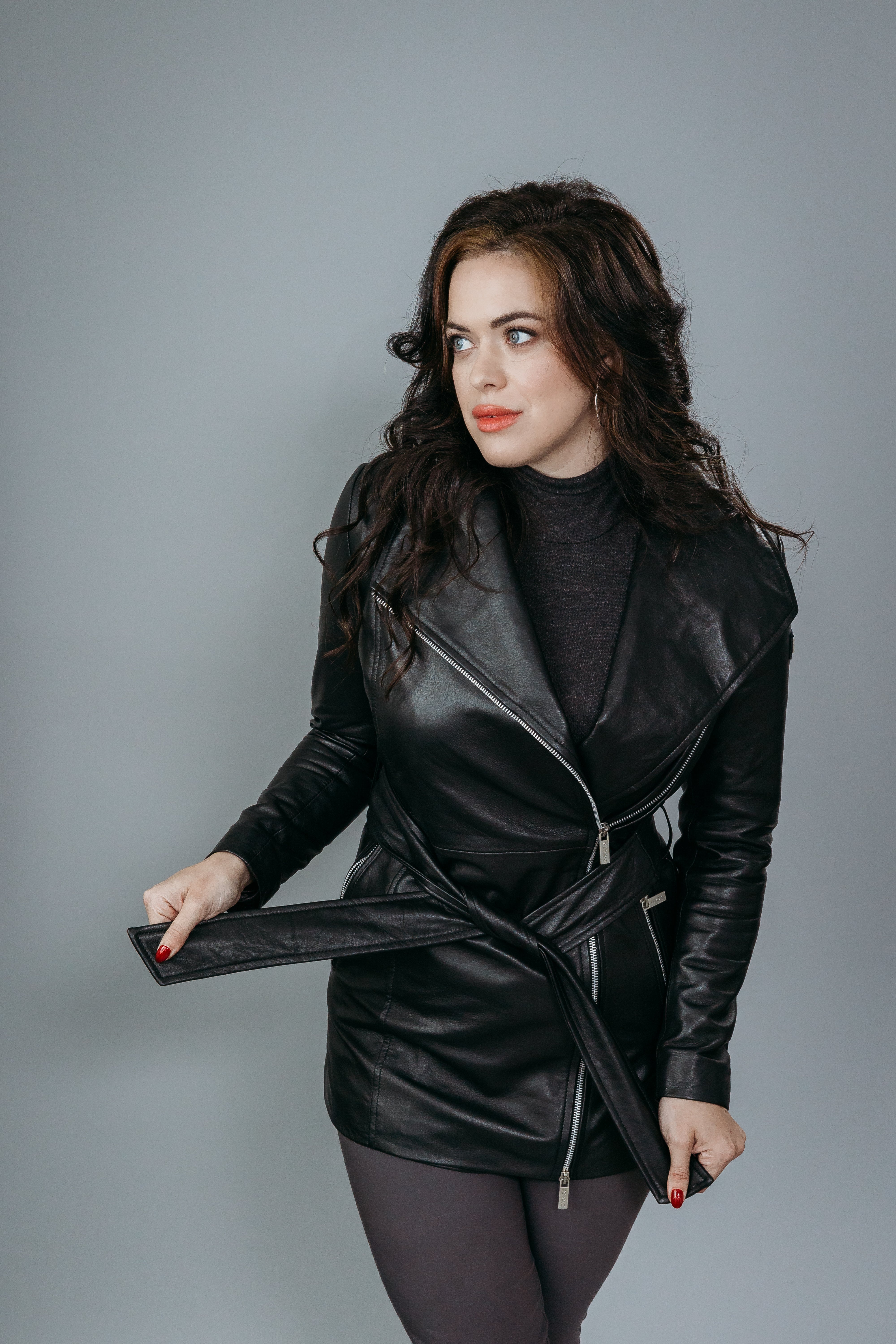 Women's Trench Coat made with Semi-Aniline Sheep Leather in Black Colour. Inner Lining is Silk Satin Material in Black Colour. It has Zipper and Matte Silver Trim.