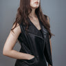 Women's Sleeveless Biker Jacket made with Perforate Semi Aniline Sheep Leather in Black Colour. Inner Lining is Silk Satin Material in Black Colour. It has Zipper and Matte Silver Trim.