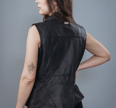 Women's Sleeveless Biker Jacket made with Perforate Semi Aniline Sheep Leather in Black Colour. Inner Lining is Silk Satin Material in Black Colour. It has Zipper and Matte Silver Trim.