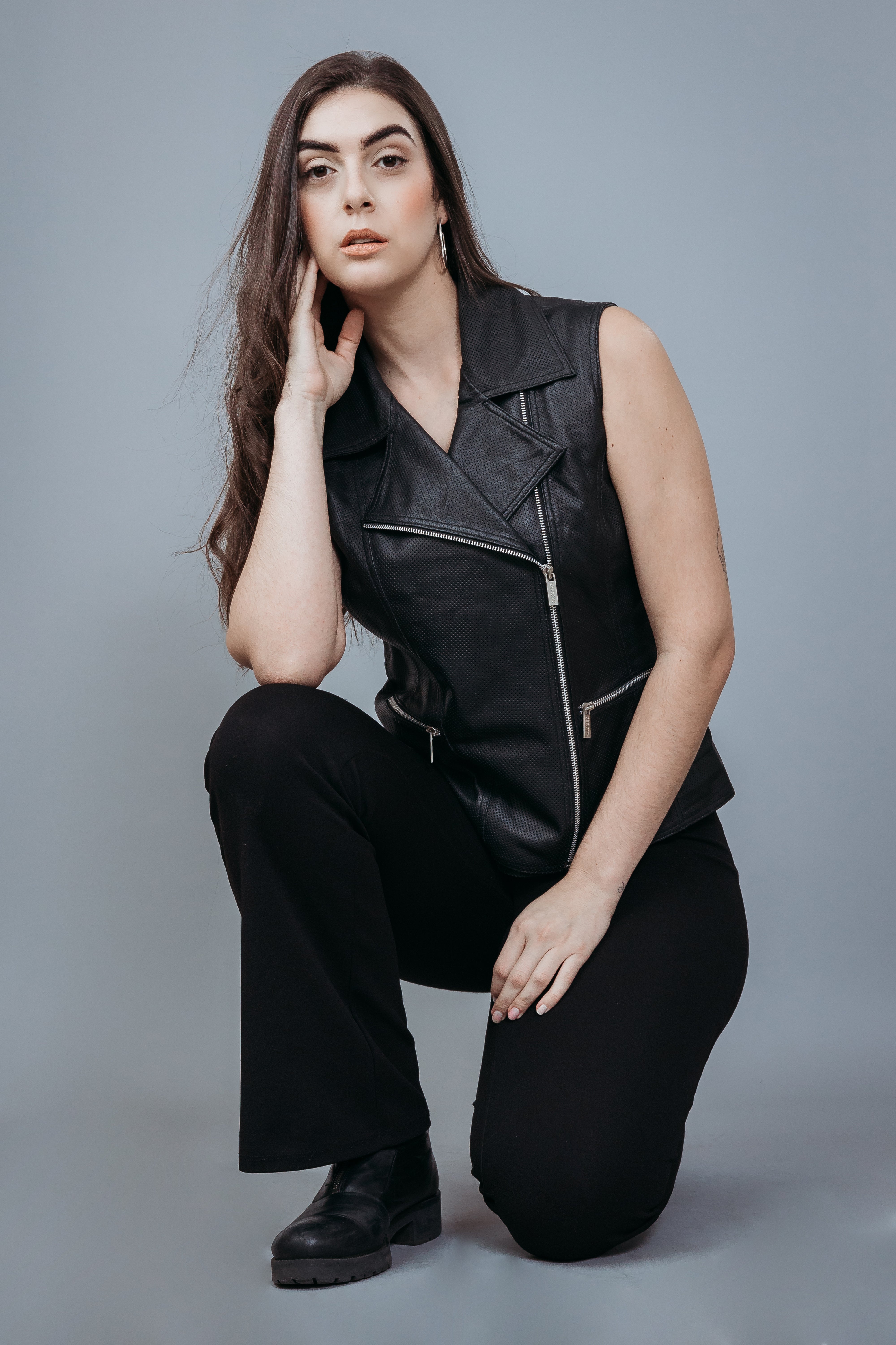 Women's Sleeveless Biker Jacket made with Perforate Semi Aniline Sheep Leather in Black Colour. Inner Lining is Silk Satin Material in Black Colour. It has Zipper and Matte Silver Trim.