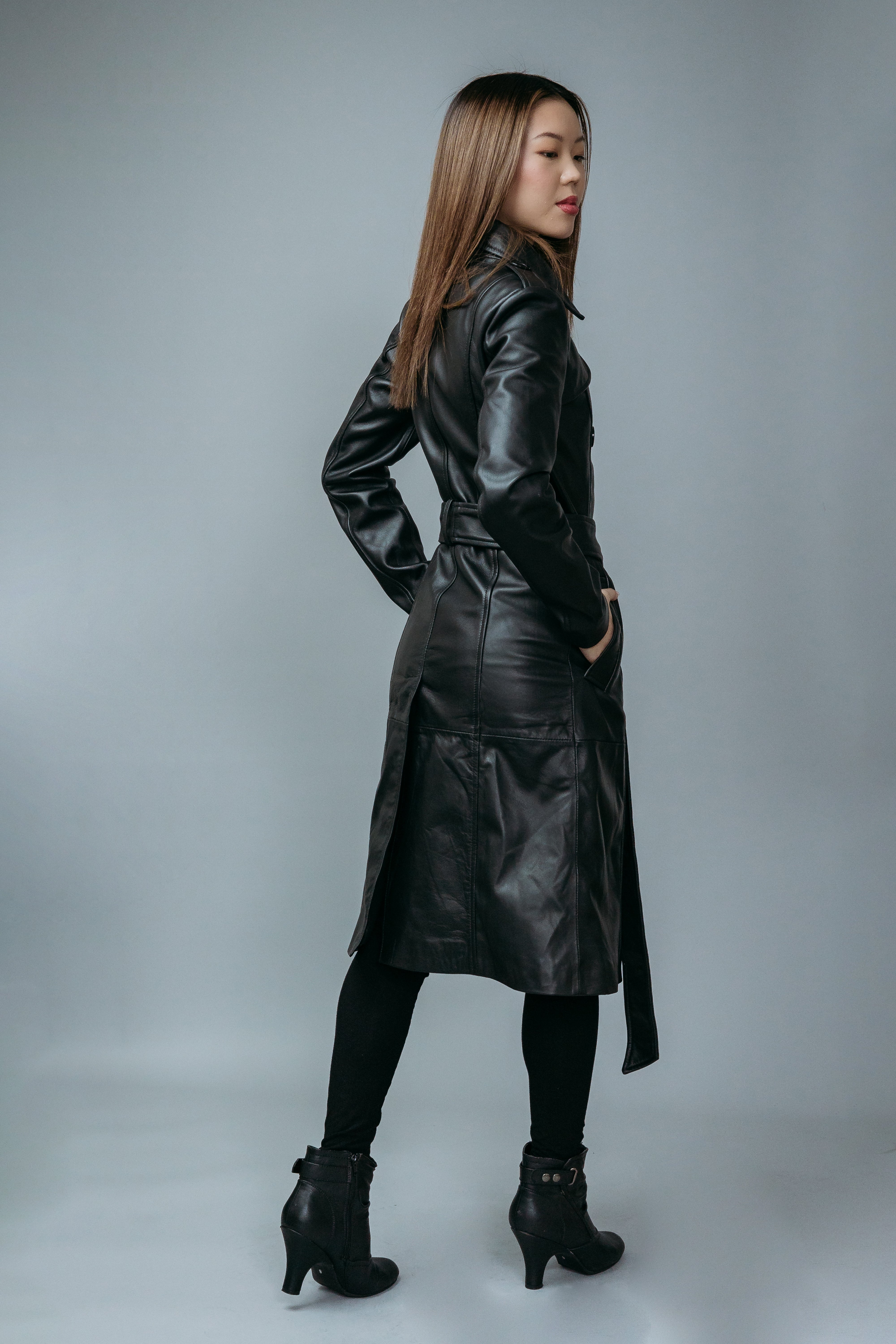 Women's Trench Coat made with Semi-Aniline Sheep Leather in Black Colour. Inner Lining is Silk Satin Material in Black Colour. It has Black Plastic Buttons.