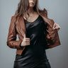 Women's Upper Style Short Jacket made with Sheep Top Grain Nappa Leather in Brown Colour. Inner Lining is Silk Satin Material in Brown Colour. It has Brown Plastic Buttons.