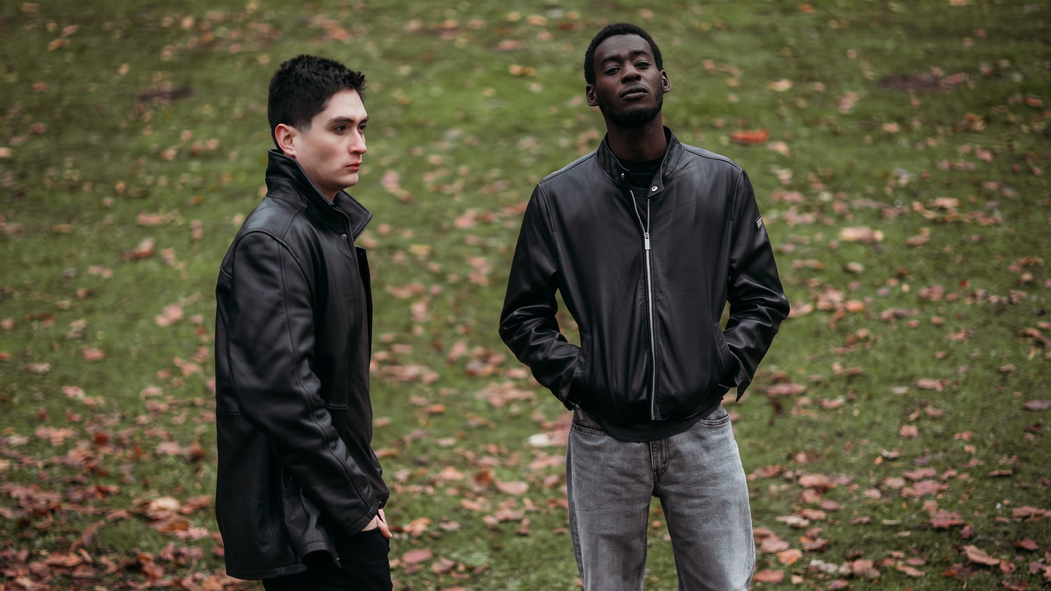 Two Men Models Wearing Peroye Leather Jackets With Grassy Background