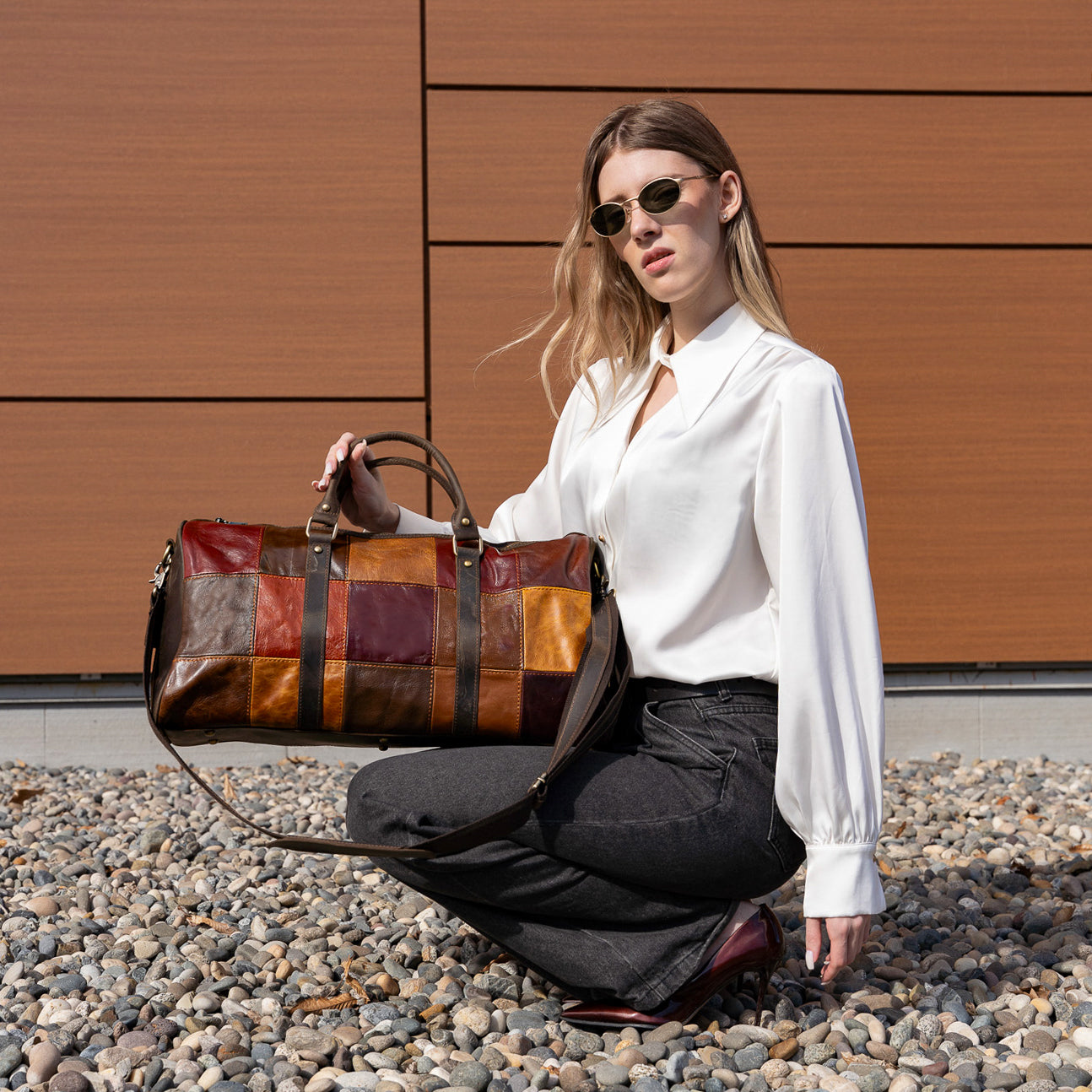 Brown leather duffel bag featured by women model